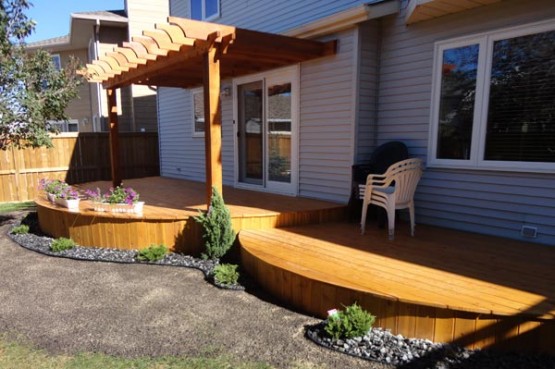 Modern Patio wooden deck with minimal garden in grey stones