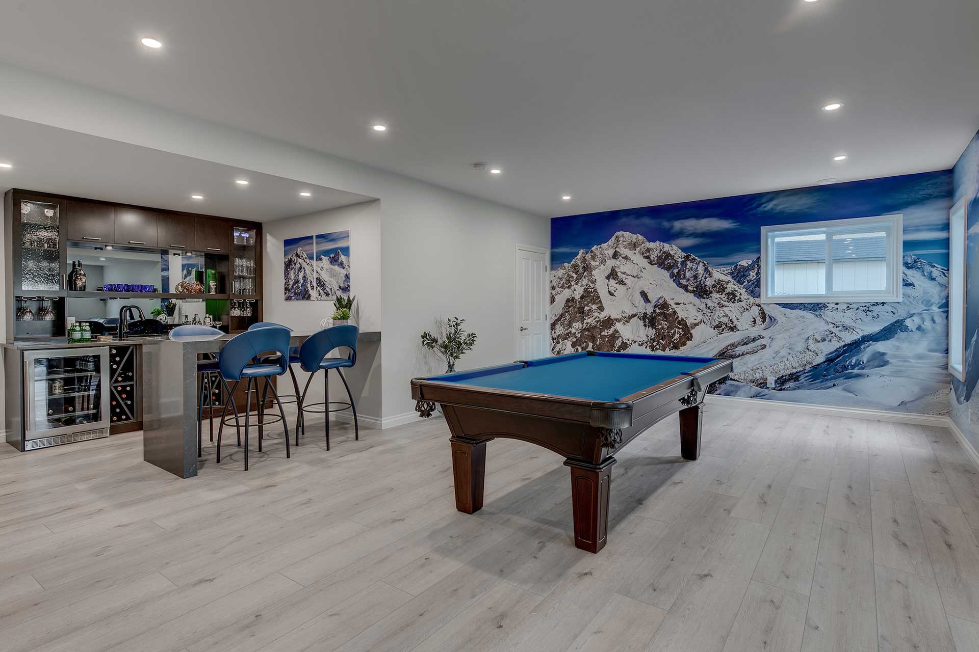pool table in room with mural of a snow-covered mountain