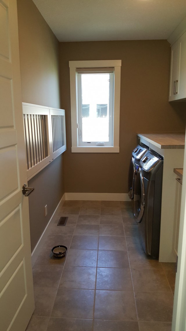 looking through door leading into renovated laundry room with washer and dryer