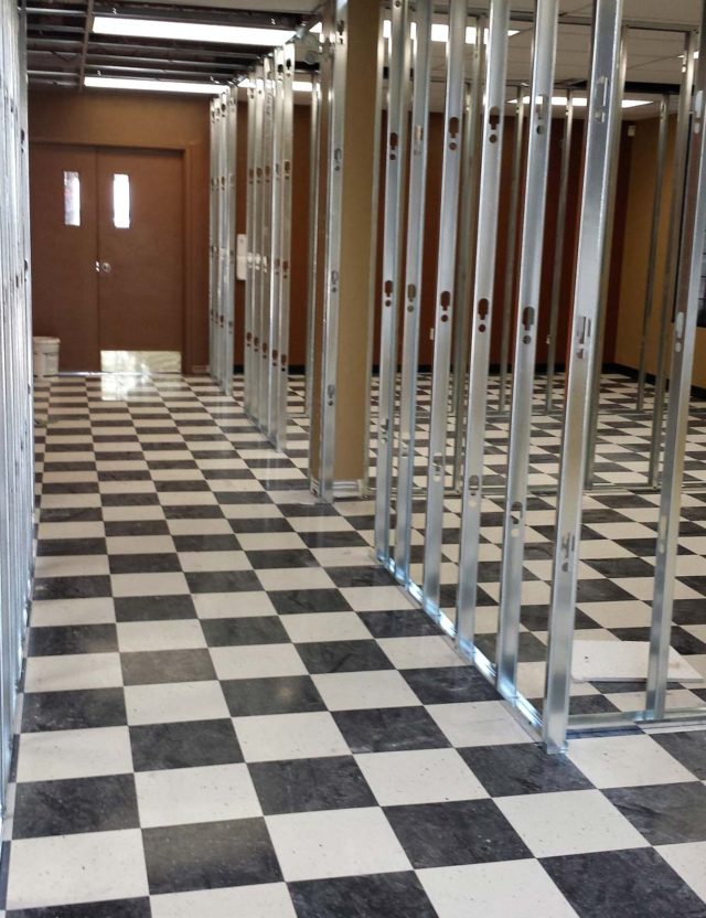 hallway with chequered floor tiling in commercial building
