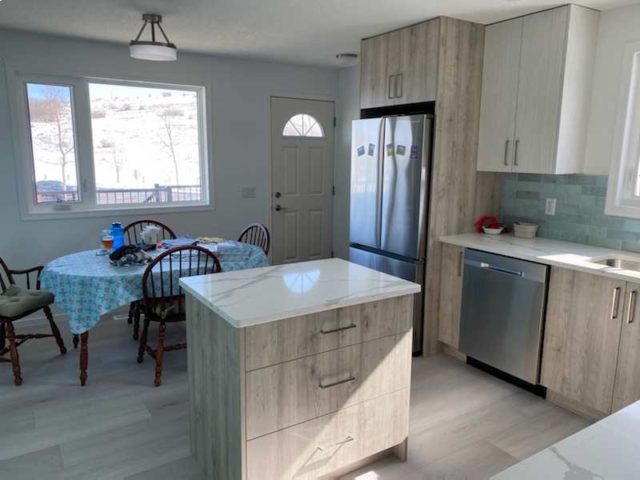 finished kitchen with marble counter tops